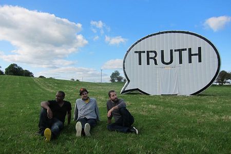 Artists Hank Willis Thomas, Jim Ricks and Ryan Alexiev pose in front of The Truth Booth at a stop in Ireland.