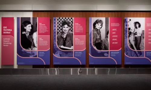 Exhibit wall in “¡De última hora! Latinas Report Breaking News” shows photos of the women featured