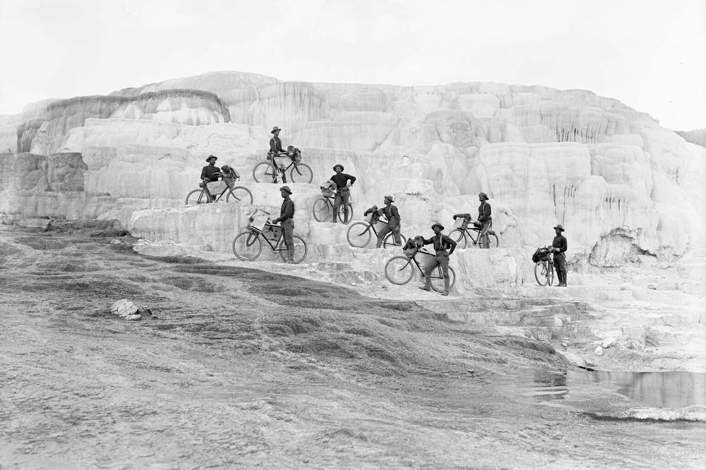 Members of the 25th Infantry Bicycle Corps pose on Minerva Terrace at Mammoth Hot Springs in Yellowstone National Park in 1896
