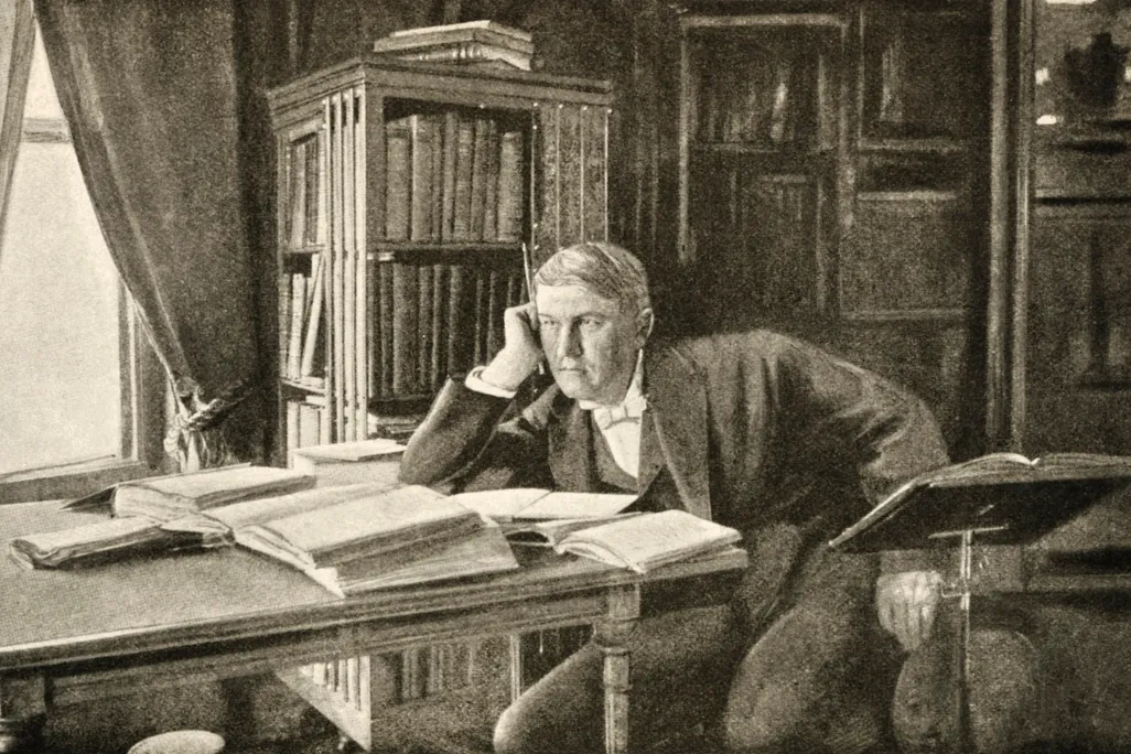 Thomas Alva Edison thinking at his desk
