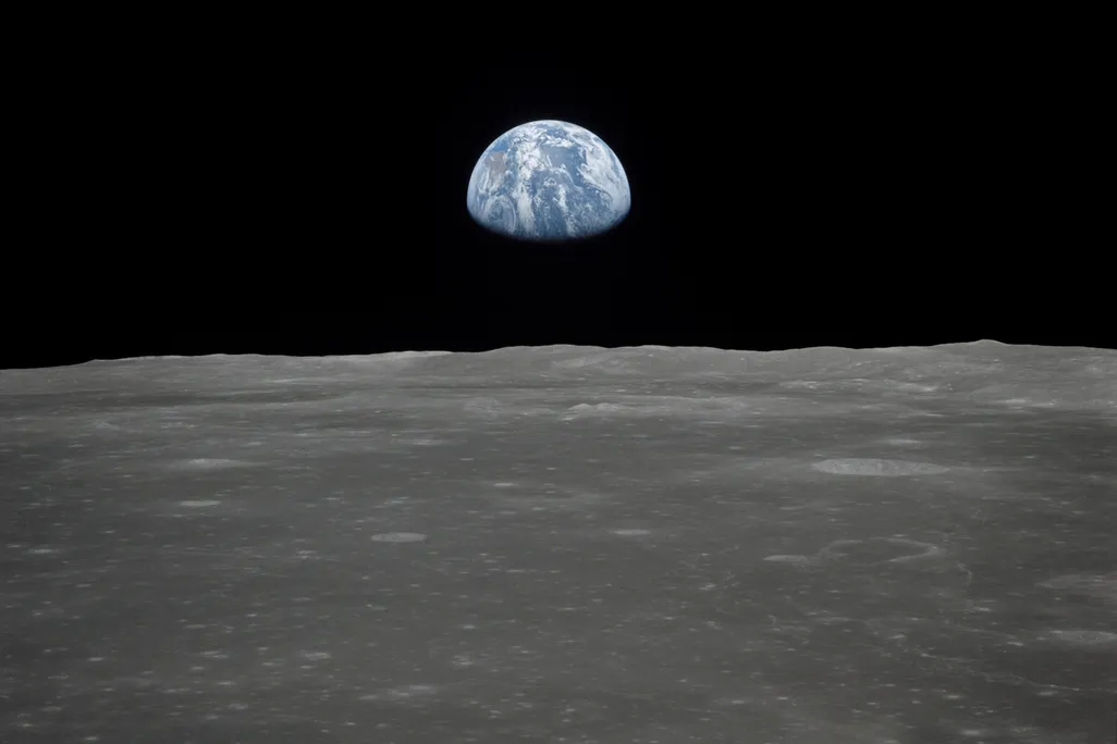 View of Earth rising over Moon's horizon taken from Apollo 11 spacecraft
