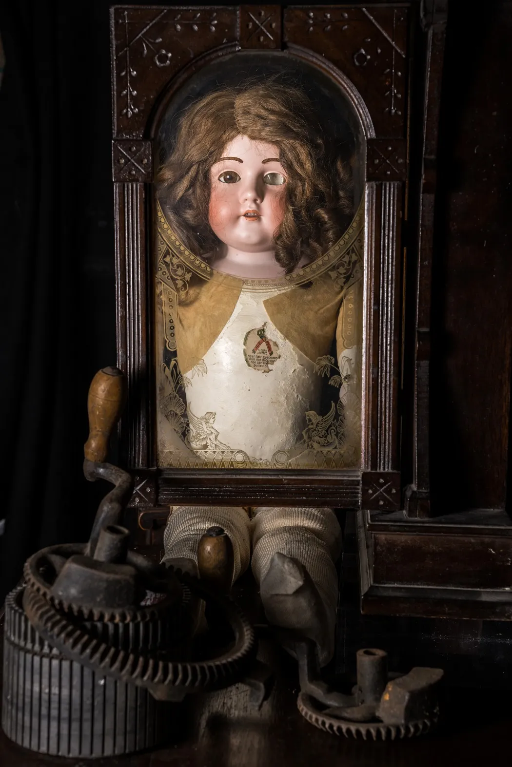 doll framed in antique window