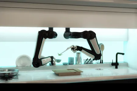 The robotic arms move across the range, cooking and cleaning. 