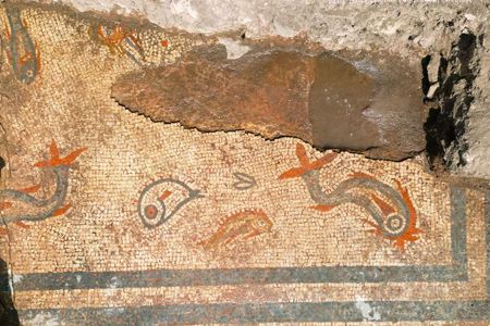 The colorful mosaic depicts brightly colored dolphins and fish.