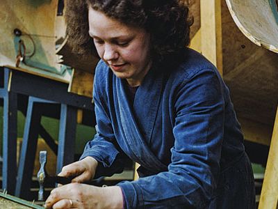 a worker prepares wood strips for a Mosquito hull