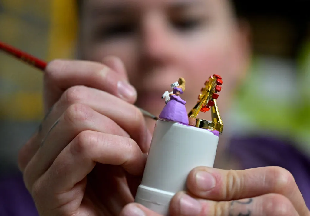 employee paints the model inside a snow globe