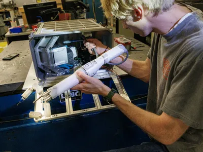 University of Nebraska engineer&nbsp;Sean Crimmins&nbsp;loads the robotic arm into its case. A surgeon on Earth will remotely guide the robot through a surgical simulation while it is on the International Space Station.