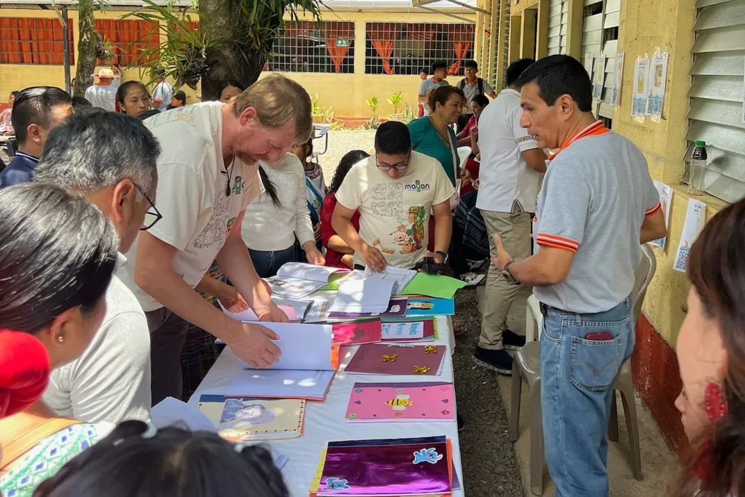 Lister García, director of Bilingual Technology Center, displays new interactive learning tools with the help of Winston Scott, MLPP’s director.