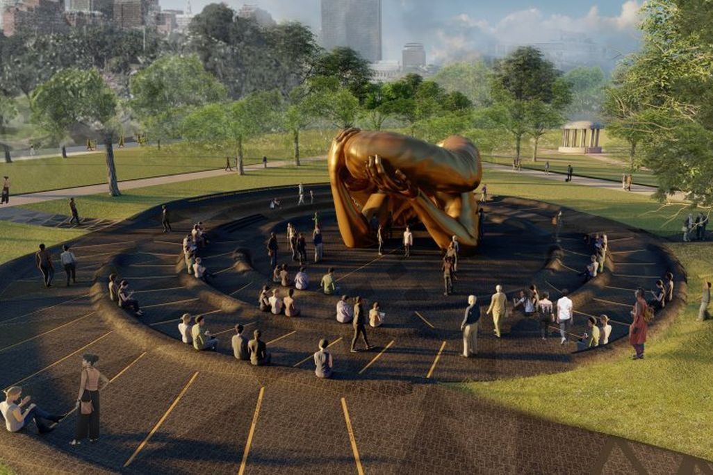 A rendering of a large sculpture of disembodied arms embracing one another, surrounded by a spiral path with ledges for sitting and the greenery of the public park around, scattered with people