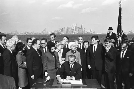 President Lyndon B. Johnson signs the Immigration and Nationality Act of 1965 on Liberty Island in New York Harbor. 
