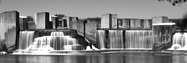 A black and white long exposure shot of Stepping Stone Falls in a serene summer day where the Flint River meets Mott Lake. Flint Michigan