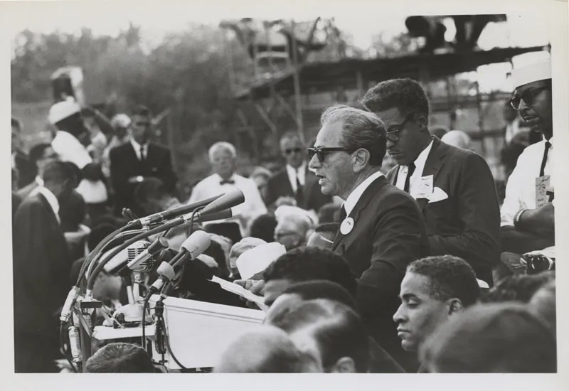 Rustin stands behind speaker Joachim Prinz during the March on Washington.