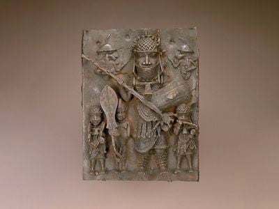 This 16th- or 17th-century copper alloy plaque&mdash;one of the ten Benin Bronzes removed from view&mdash;depicts a&nbsp;high-ranking warrior flanked by&nbsp;musicians and a page holding a ceremonial sword.
