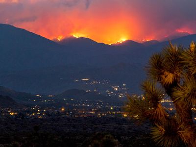 Flames and smoke cover the hillsides near Yucca Valley in California during a June wildfire.