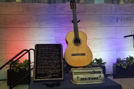 Clockwise from upper right, the items Feliciano donated to the Smithsonian included: his beloved Concerto Candelas guitar, a Braille writer his wife Susan used, a pair of his trademark glasses, and a heartfelt embroidered note from a Japanese admirer.