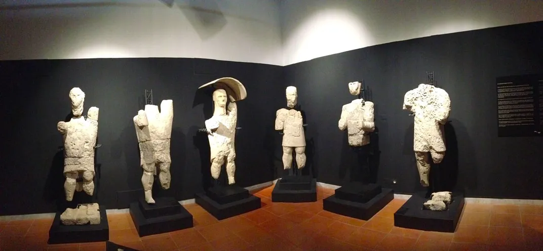 Towering giant statues displayed in a museum