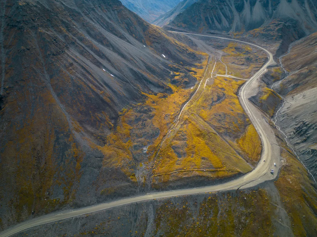 Vehicles seemingly lean to the side as they cling to the Dalton Highway’s Atigun Pass (elevation: 4,739 feet), along the Brooks Range.