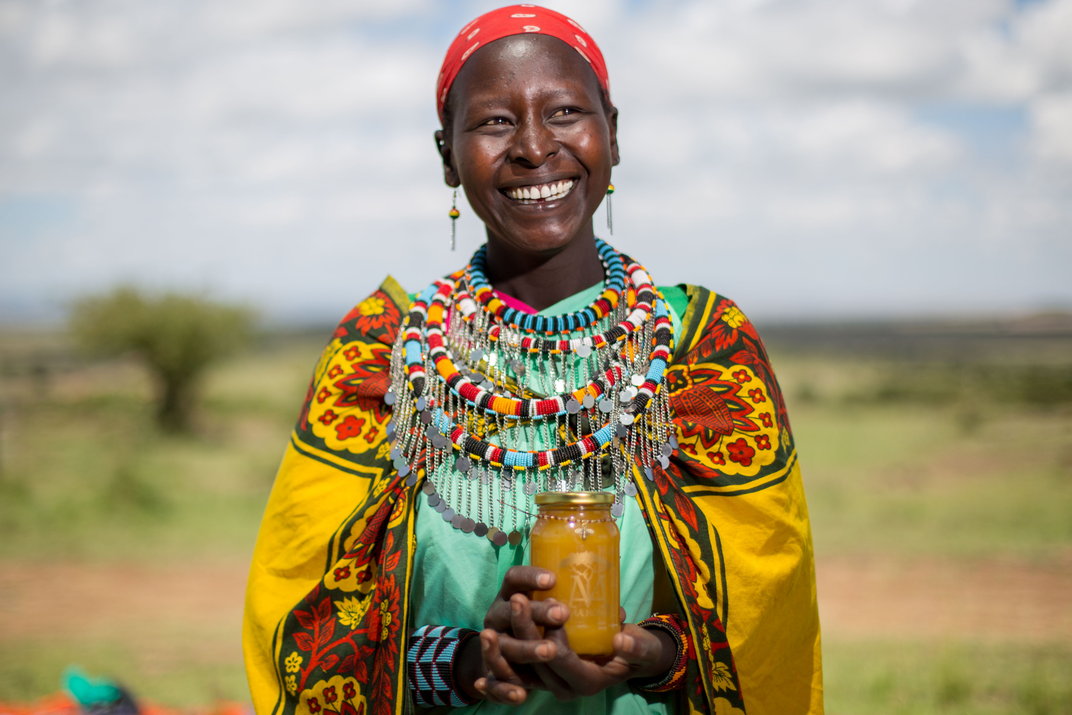 Maasai Woman holding honey
