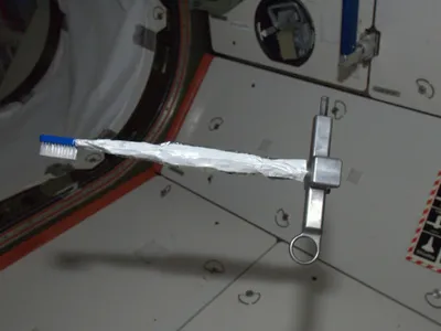 A toothbrush floats in the International Space Station.