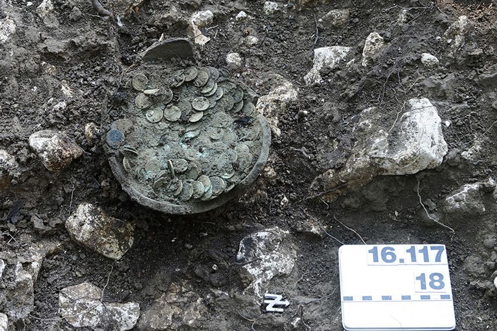 Coins in a clay pot
