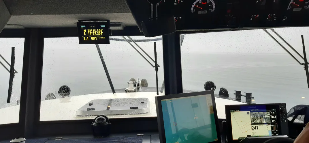 computers at the front of the research boat and windows out to sea