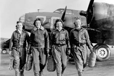 Frances Green, Margaret (Peg) Kirchner, Ann Waldner and Blanche Osborn leaving their plane, "Pistol Packin' Mama," at the four-engine school at Lockbourne AAF, Ohio, during WASP ferry training. 