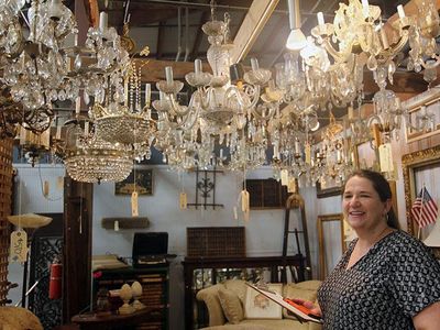 Ruthie Mundell stands among new and vintage chandeliers—all salvaged and ready to find a new home.