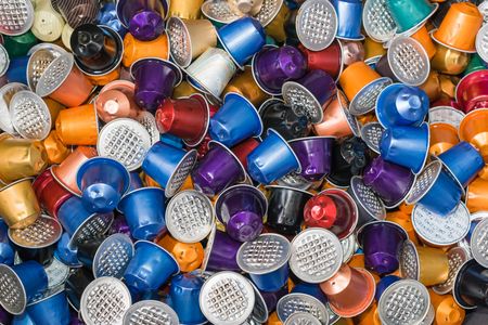 A huge pile of used disposable Nestle Nespresso coffee capsules in various colors on a garbage heap in Switzerland. The popular capsules are collected after use in order to recycle the aluminum parts.