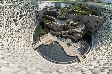 A view from the cell wall of the Shanghai Natural History Museum, looking down on the north tectonic wall made of stone.
