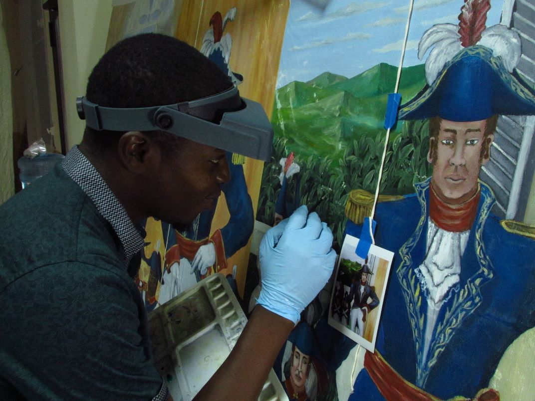 Conservator treating Haitian painting