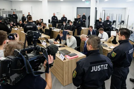 Defendants sit next to their lawyers at the Higher Regional Court in Dresden on January 10, 2023.