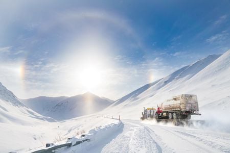 With a sunny &ldquo;halo&rdquo; to point the way, a truck climbs into the Brooks Range towards Atigun Pass, heading for Fairbanks after departing the oilfields of Prudhoe Bay.

