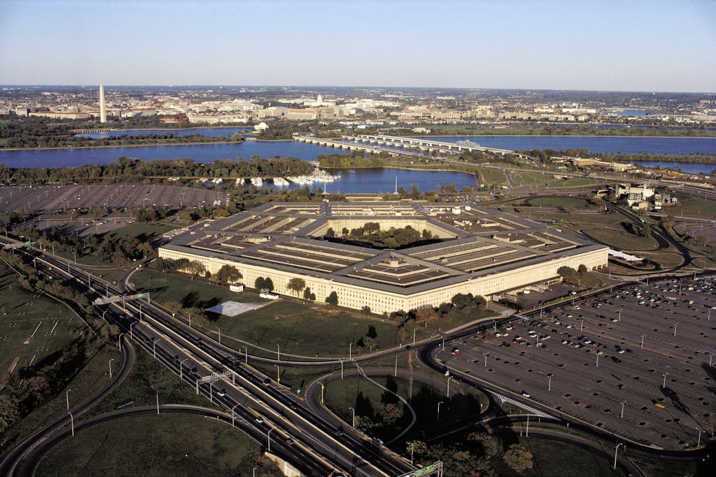 An aerial view of the Pentagon with Washington, D.C, and the Washington Monument in the background