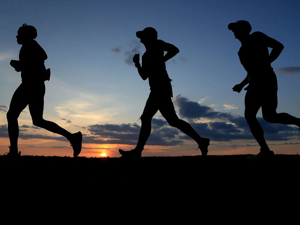 Runners In Hawaii At Sunset