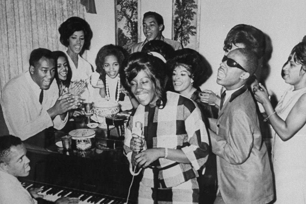Berry Gordy surrounded by Motown stars