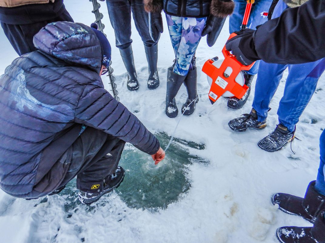 Students in Noatak take ice measurements