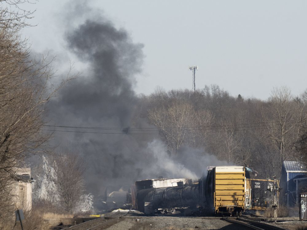 Smoke rises from derailed train cars in East Palestine, Ohio.