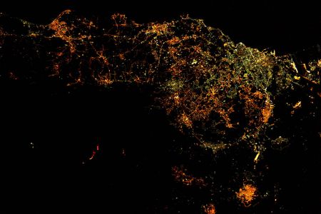 Mount Etna's glowing lava flow can be spotted at bottom left. 