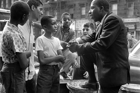 Civil Rights activist Grady O'Cummings talking with a group of boys. O'Cummings later faked his own death to avoid threats made by members of the Black Panthers against him and his family.