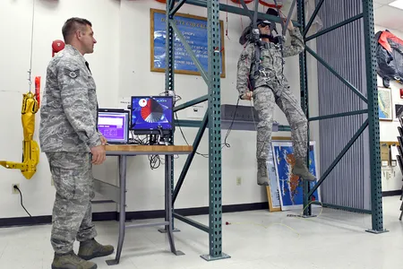 A U.S. Air Force Survival, Evasion, Resistance, and Escape specialist trains on PARASIM. The parachute straps and steering controls connect to sensors that adjust the simulation displayed inside the trainee's virtual reality helmet.