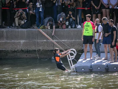 The mayor of Paris, Anne Hidalgo, took a brief swim in the Seine River wearing a wetsuit and goggles on July 17.