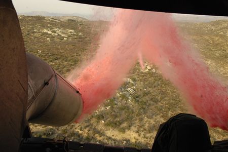 071025-F-5735S-100 

      Three-thousand gallons of fire retardant are deployed from a C-130 Hercules aircraft over the Witch fire in Northern San Diego, Calif., on Oct. 25, 2007.  The C-130 and its crew are assigned to the 302nd Airlift Wing out of Peterson Air Force Base, Colo.  DoD photo by Tech. Sgt. Roy A. Santana, U.S. Air Force.  (Released)