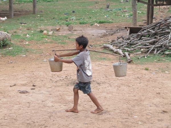 Laotian children go to fetch water thumbnail