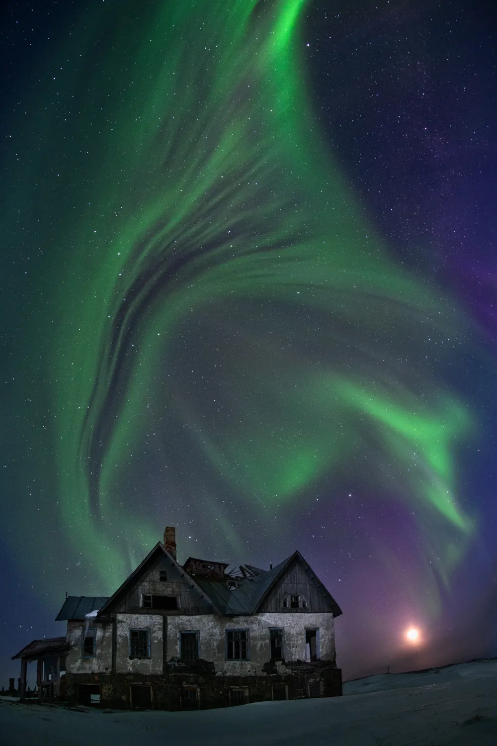 Magical Aurora Borealis over an abandoned house in the village of Dalnie Zelentsy (Murmansk region).