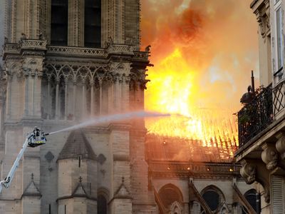 A firefighter is seen fighting the flames at Notre-Dame Cathedral on April 15, 2019