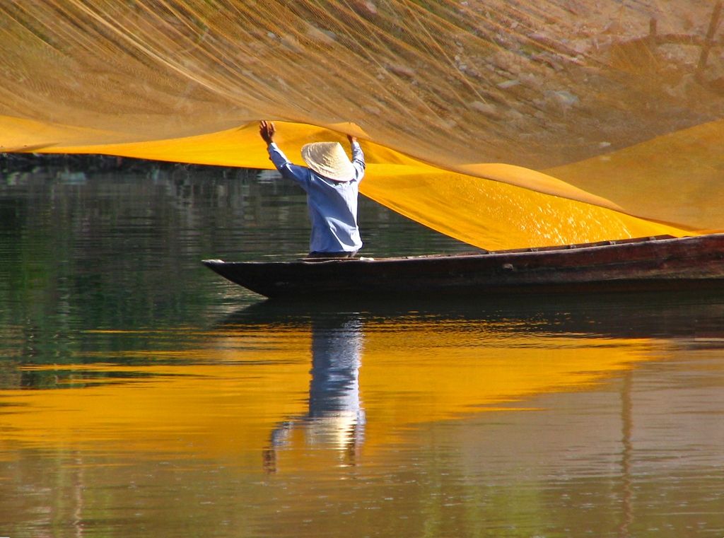 Throwing fishing nets along the river in Vietnam. Credit: Amanda Mack