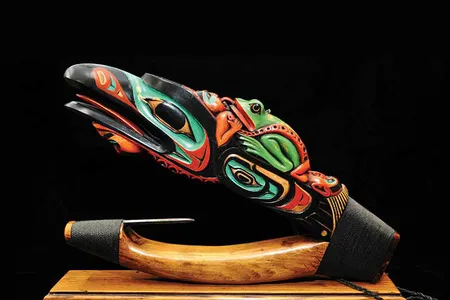 Tlingit artist Arthur B. Nelson’s Devil Fish Halibut Hook, 2012, is an impressive example of a contemporary wooden halibut hook designed to be a piece of art rather than a functional example of halibut fishing equipment. The carving depicts raven, frog, octopus, and human spirits. 