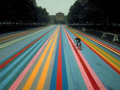 Gene Davis at work on his painting Franklin's Footpath, created on the street outside of the Philadelphia Museum of Art in 1972.