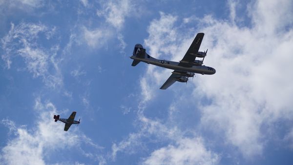 A red tail P-51 escorts FIFI, a B-29, to its final resting place thumbnail