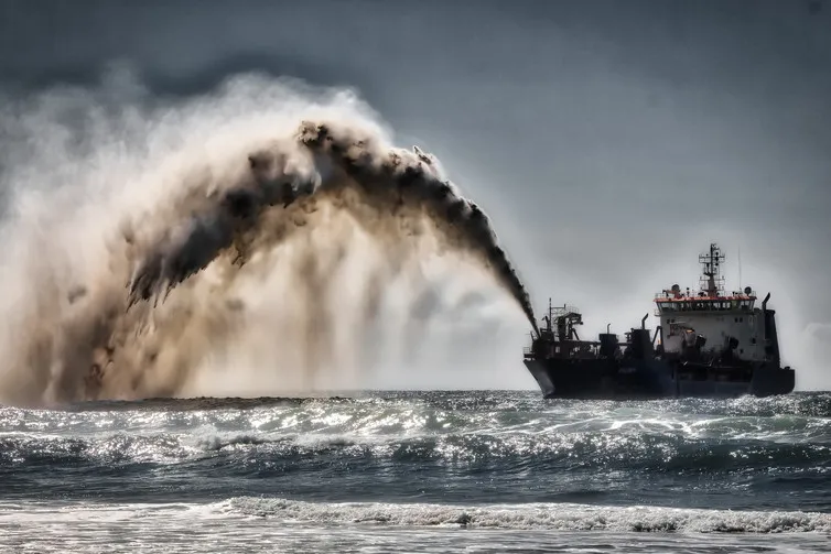 Dredger pumping sand